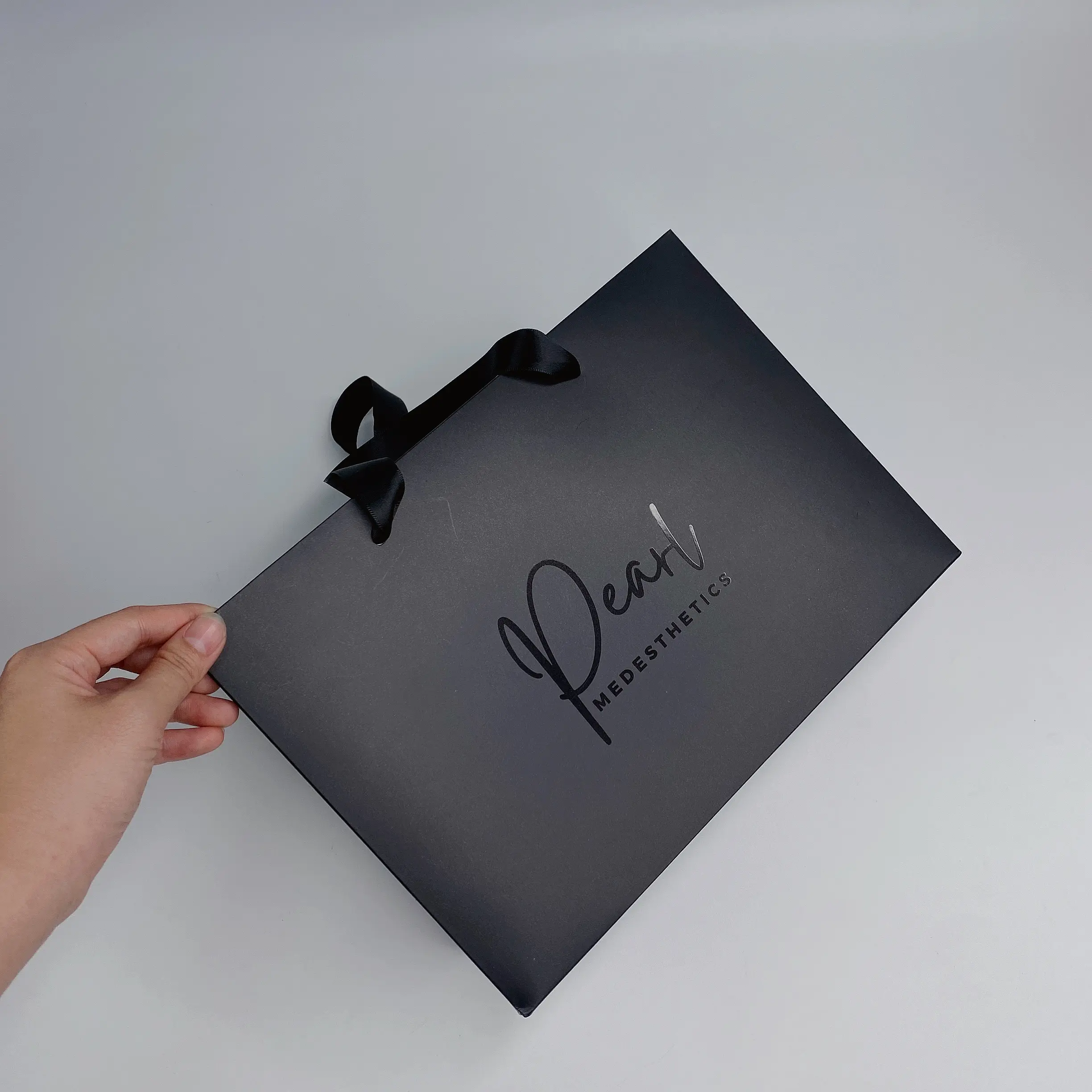 Luxury black paper bag with ribbon handle